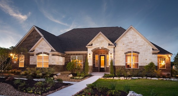 Nice house with lights on at sunset